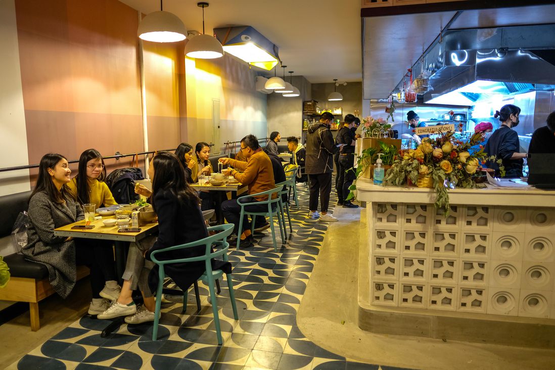 Diners enjoy a meal at tables inside the Banh Vietnamese Shop House in NYC during the COVID-19 pandemic.